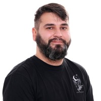 Between Technology Employee Miguel Cardona's profile photo
